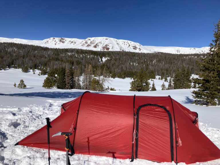 Red tent set up in the snowy mountains