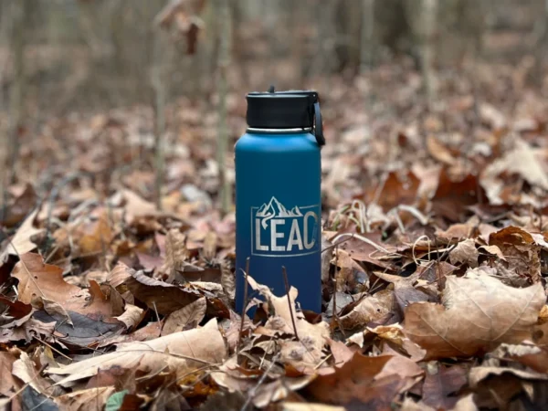 Multi-green Lead Your One Life water bottle in leaves